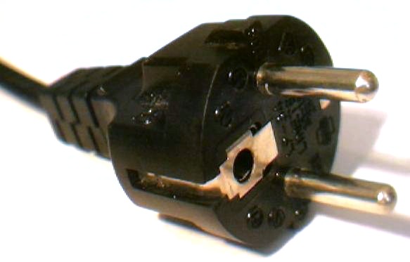 Two round pins with a pair of metal tabs on either side of the plug, one of which wraps around onto the bottom where it has a hole in it.